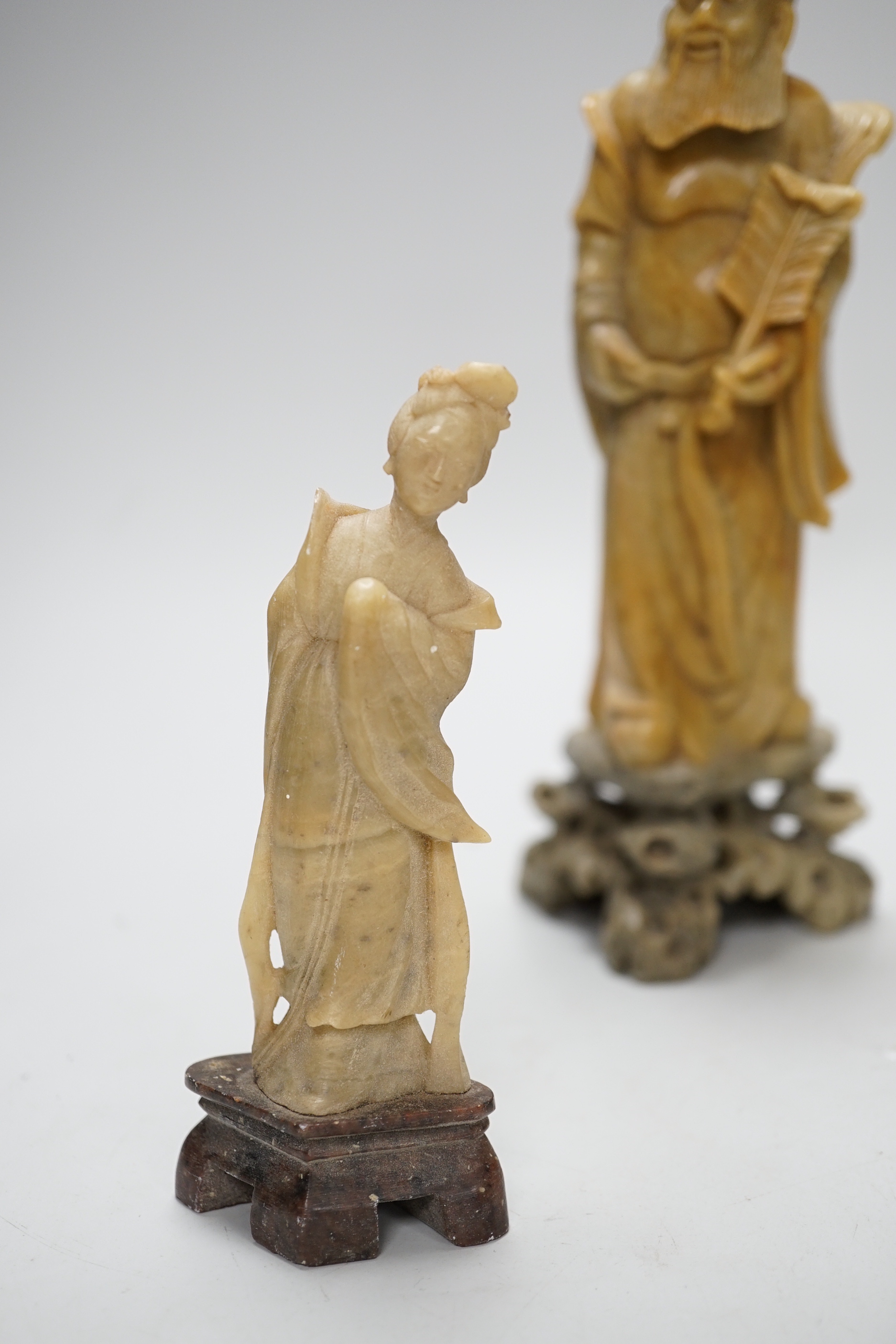 A Chinese bowenite figure and four Chinese carved soapstone figures, the largest 21cm high (5)